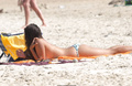 Elena Furiase sunbathing topless on a beach