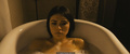 Daniella Pineda in a bathtub scenes from Mercy Black (2019)